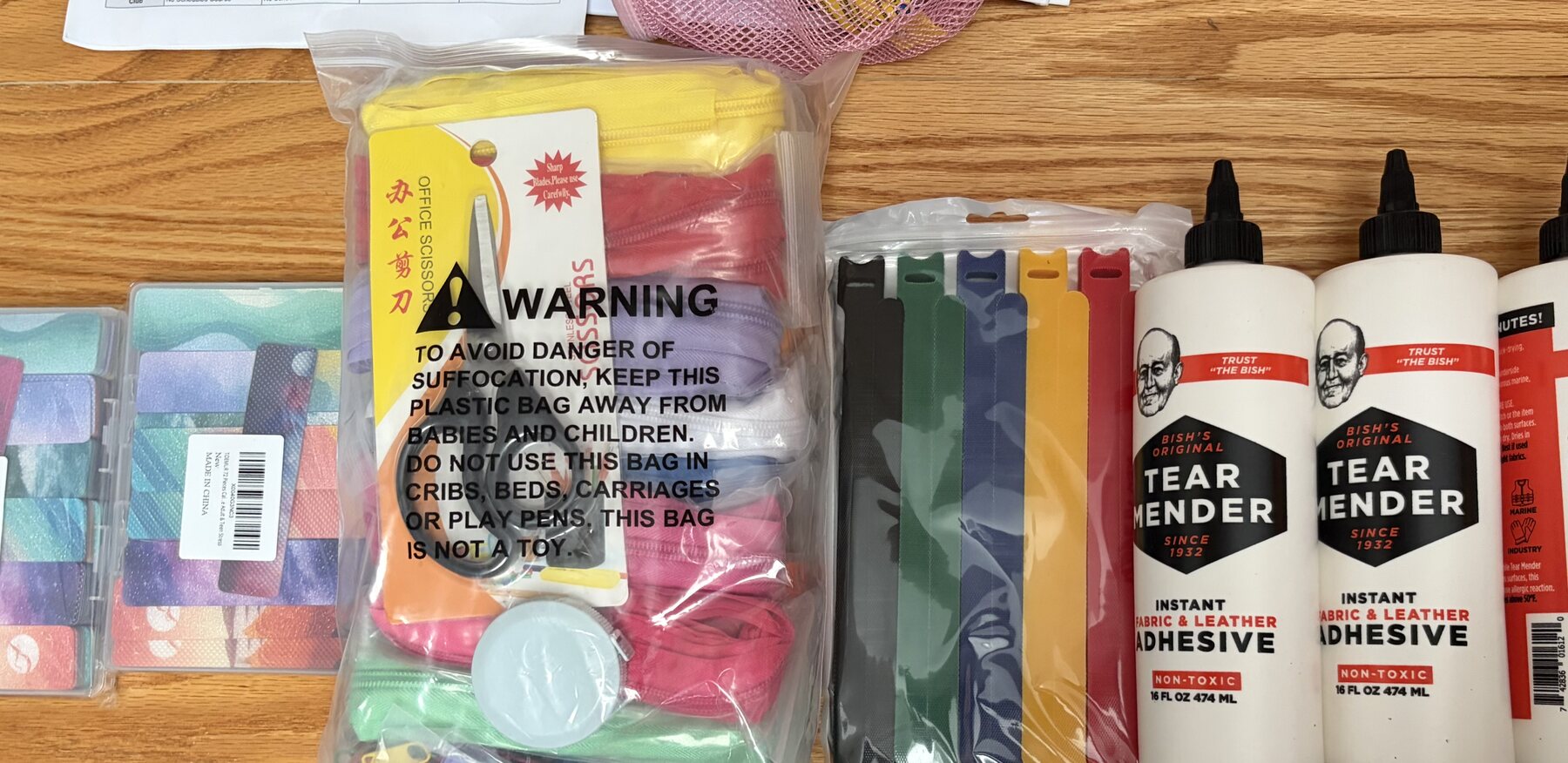 Zippers, felt, textured pieces, sequins, fabric glue, and other sensory-cape supplies
