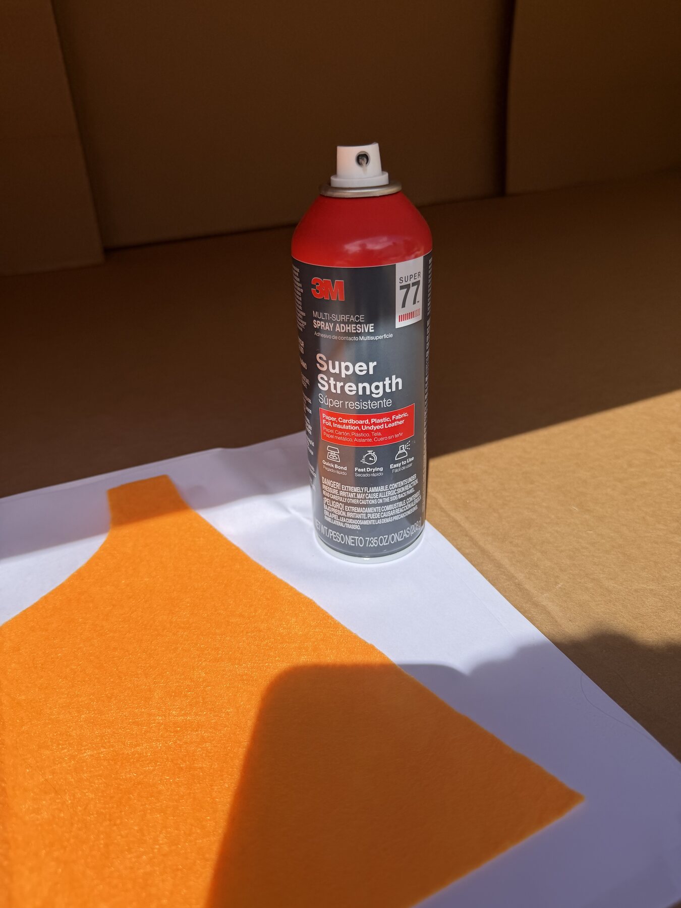 Fabric layers and spray adhesive used to make a no-sew cape
